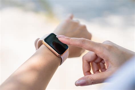 Close Up Shot Of Females Hand Touching A Smartwatch At Outdoor In