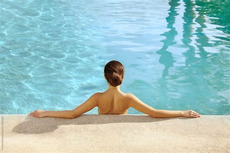 Beautiful Hispanic Woman Relaxing In Swimming Pool At Luxury Resort