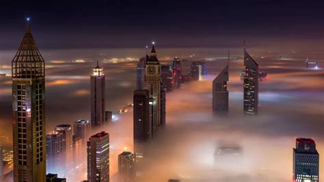 Stunning Pictures Show Dubai Skyscrapers Peeking Out Over Thick Fog As