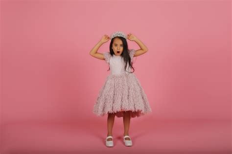 Premium Photo A Small Darkskinned Beautiful Girl In A Lush Pink Dress