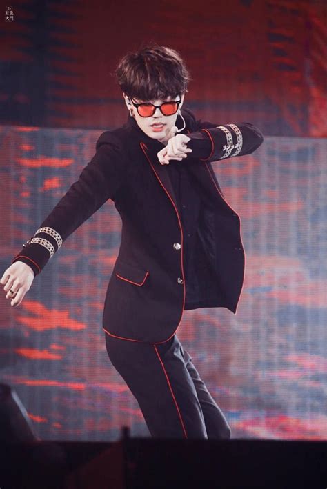 A Man In Black Suit And Sunglasses On Stage