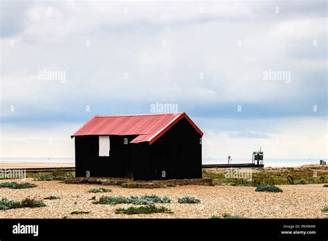 Grans Hut A Corrugated Black And Red Hut On A Shingle Beach At Rye