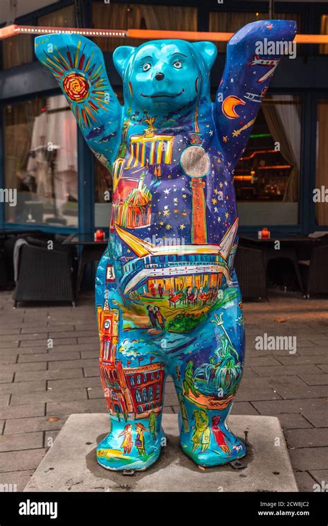 Colorful fiberglass Buddy Bear statue, the symbol of Berlin raising his ...