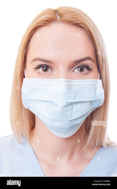 Portrait Of A Beautiful Woman Doctor Wearing Surgical Mask Isolated On