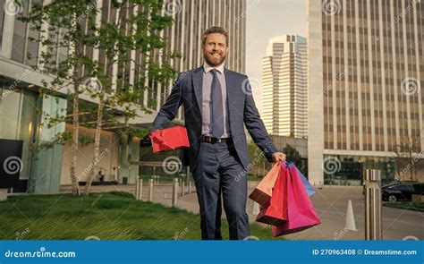 Laughing Charismatic Mature Businessman In Suit Hold Packages And Gift Box Outside The Office