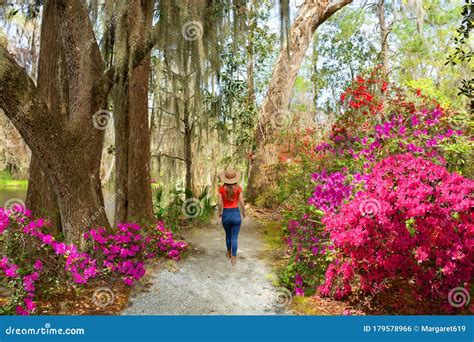 Girl Walking Alone In Beautiful Garden On Spring Trip Stock Photo