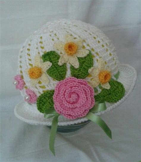 A Crocheted Hat With Flowers On It