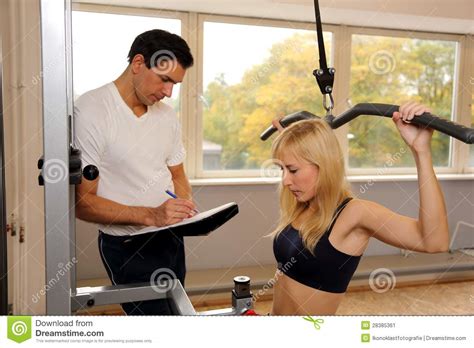 Attractive Blonde Woman And Her Trainer In A Gym Stock Image Image Of Energy Muscular 28385361