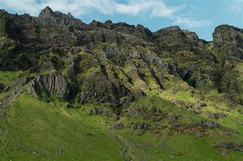 Una representación digital de un paisaje montañoso con un campo verde y