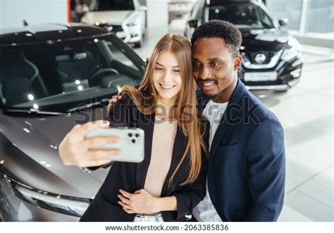 Happy Multi Ethnic Couple Using Modern Smartphone For Taking Selfie