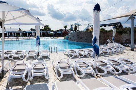 Premium Photo | Swimming pool with sun loungers and umbrellas in the resort