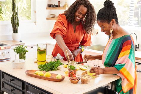 Mature Black Women Friends Cooking Together In The Kitchen Having Fun By Stocksy Contributor