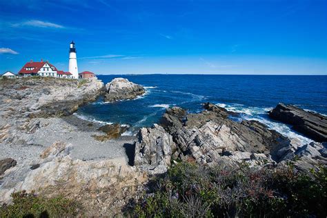 Rocky Shoreline With Lighthouse Portland Head Main Photograph By George Oze