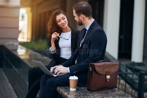 Beautiful Brunette Woman Holding Glasses Looking At Her Colleague Stock Photo Image Of