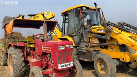 Jcb Dx Backhoe Loader Machine Loading Mud In Mahindra Di Tractor