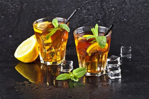 Two Glasses With Cold Traditional Iced Tea With Lemon Mint Leaves And