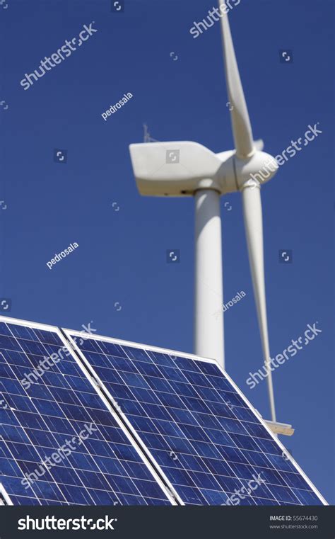 Windmill And Solar Panel With A Clear Blue Sky Stock Photo 55674430