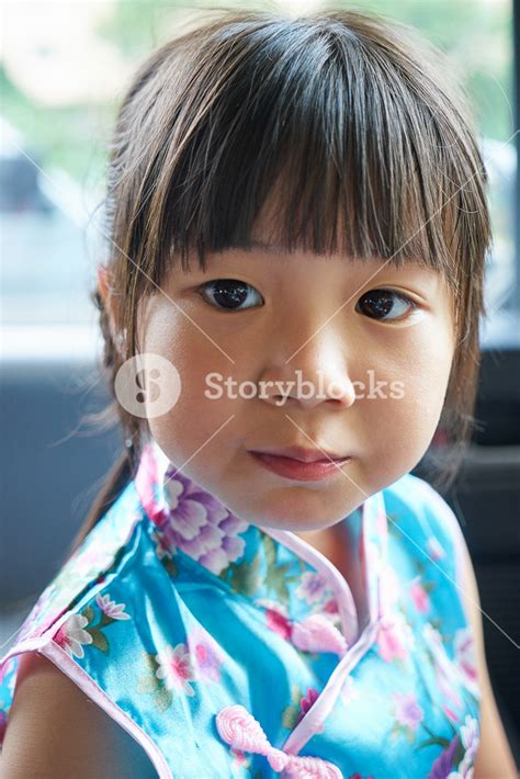 Adorable Young Girl In A Vibrant Red Chinese Outfit Royalty Free Stock