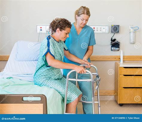 Patient With Walker While Nurse Assisting Her In Stock Photo Image Of