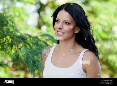 Beautiful Brunette Girl Relaxing In The Park Wiht Many Plants Of Background Stock Photo Alamy