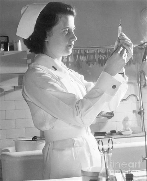 Army Nurse Preparing Injection By Bettmann