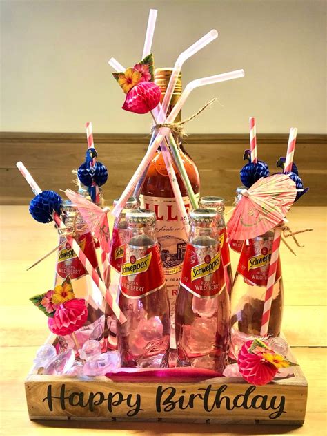 A Birthday Cake Made Out Of Soda Bottles And Straws