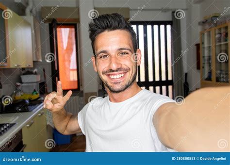 Handsome Caucasian Man Taking A Selfie Portrait Indoor At Home Happy