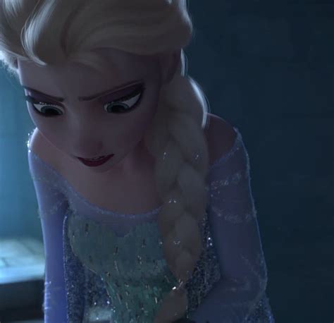 The Frozen Queen Is Looking At Something In Her Hand