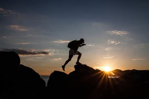 Man Jumping On Cliffs In Sunset Stock Image Image Of Danger Nature