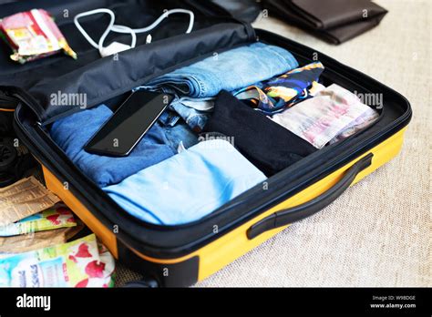 An Open Suitcase With Men S Clothing Packed For A Business Trip Or