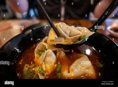 Close Up Selective Focus On Dumplings Inside A Bowl Of Hot And Sour Soup At A Chinese