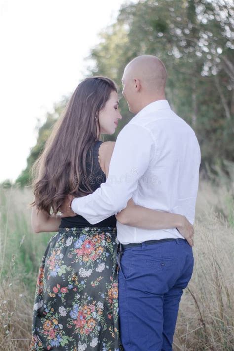 Happy Couple In Love Husband And Wife Brunette And Bald Man In The Field Or Forest Successful