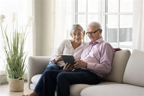 Mature Daughter Helps To Older Father With Digital Tablet Usage Stock Image Image Of Learn