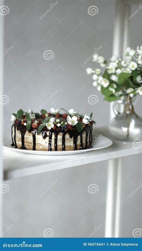 Naked Drip Cake With Chocolate Decorated With Strawberries Jasmine Flowers And Honeysuckle On