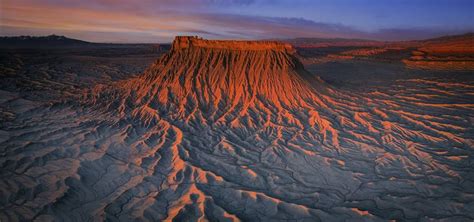 an aerial view of the desert at sunset