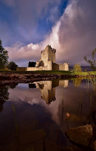 Premium Photo Castle And Clouds Lake Reflections In Killarney