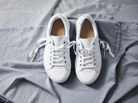 Premium Photo | Stylish White Sneakers and Jeans on Grey Background 6