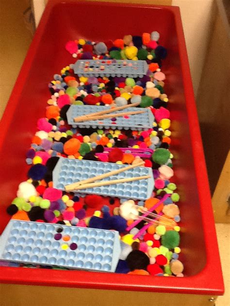 Playfully Learning Sensory Table Idea Pom Poms