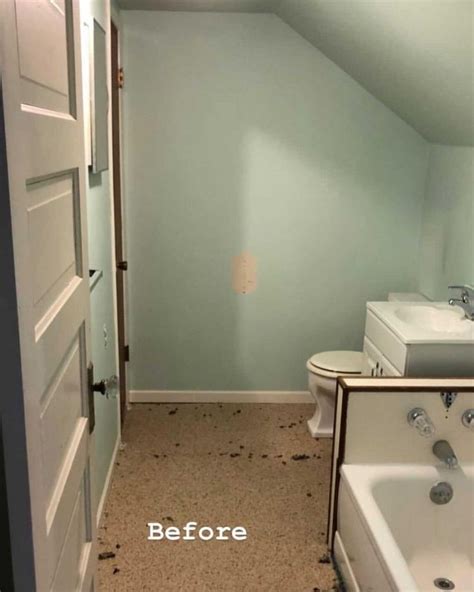 An Empty Bathroom With Blue Walls And White Fixtures On The Floor Is