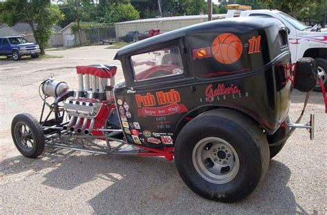 An Old School Hot Rod Car Parked In A Parking Lot