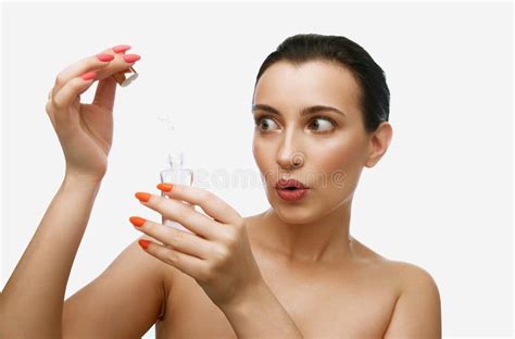 Shot Of Adorable Brunette Woman With Natural Makeup And Perfect Skin Holding Face Cosmetic With