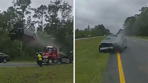 Car Flies Through Air After Hitting Tow Truck Ramp During Accident Cleanup