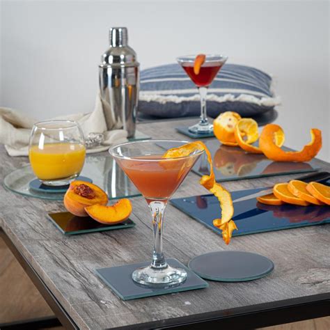 A Table Topped With Plates And Glasses Filled With Orange Peels On Top