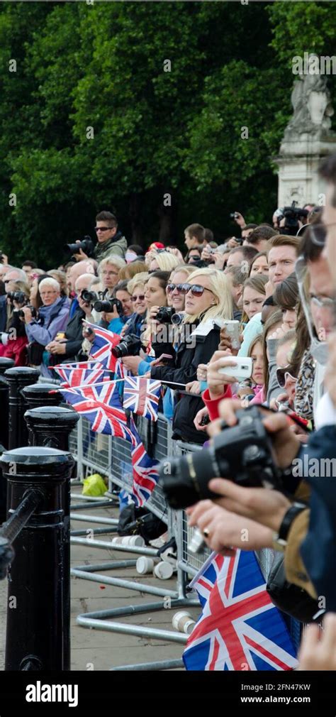 Crowd Waving Union Jack Flags Outside Buckingham Palace Trooping The