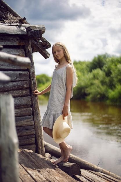 Premium Photo Portrait Of A Beautiful Village Girl Blonde With Long Hair In A Dress And Hat
