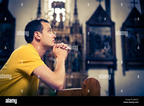 Handsome Young Man Praying In A Church Stock Photo Alamy