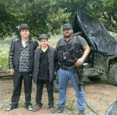 Three Men Standing Next To Each Other In Front Of A Truck