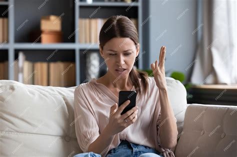 Premium Photo Confused Angry Woman Having Problem With Phone Sitting