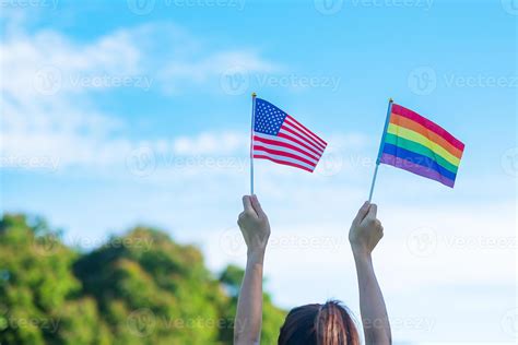 Hands Showing LGBTQ Rainbow And America Flag On Nature Background Support Lesbian Gay