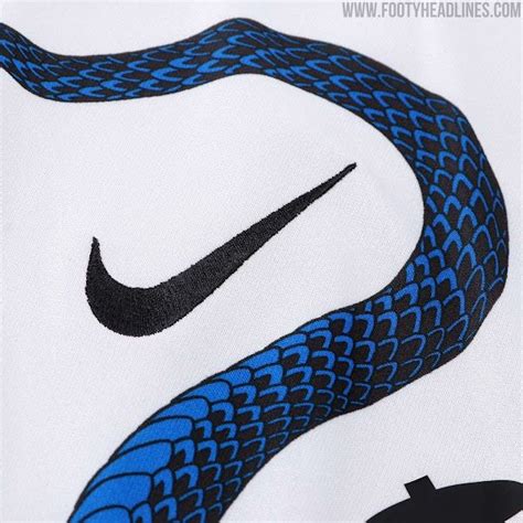 A Blue Snake On A White T Shirt With Black And Blue Details Is Shown